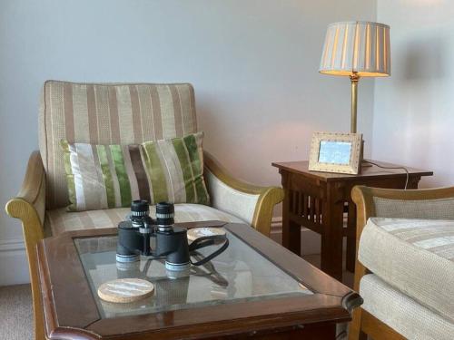 a living room with a couch and a coffee table at 10 Yards from Sea Hightide – Own Access to Beach in Sheringham