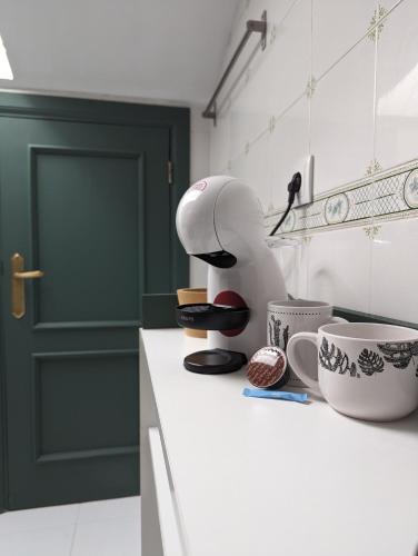 a kitchen with a coffee maker on a counter at Ático San Juan 2 in Cáceres