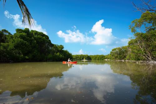 a person in a red kayak on a river at Silver Oasis Maldives in Huraa