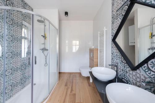 a bathroom with two sinks and a shower at Laland Apartment in Karlovy Vary