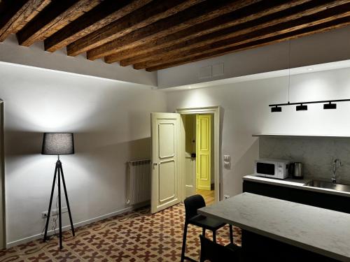a kitchen with a table and a yellow door at SAN LORENZO APARTMENTS 5054 in Venice