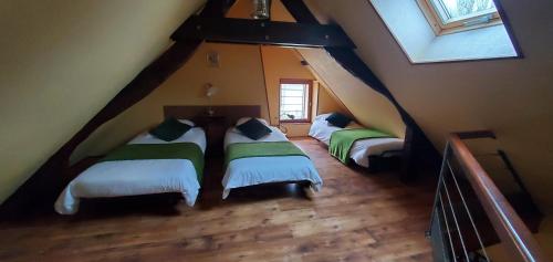 a room with three beds in a attic at GITE LE FOUR DE SULIATUS in Seuillet