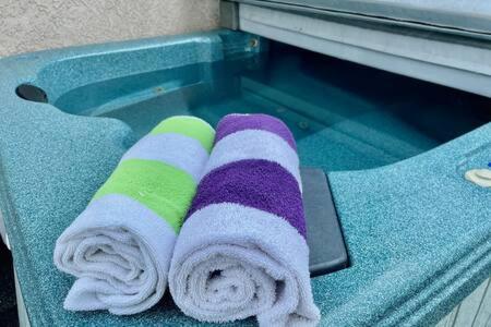 a pair of towels on a counter next to a swimming pool at Crazy Cow Private HOT TUB BBQ Sleeps 2 in Ahwahnee