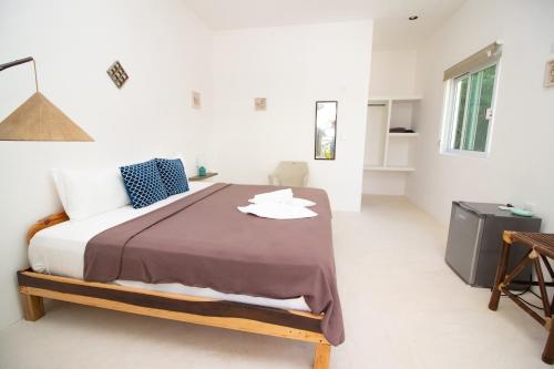 a bedroom with a large bed in a white room at Hotel Encanto Holbox Beach Front in Holbox Island