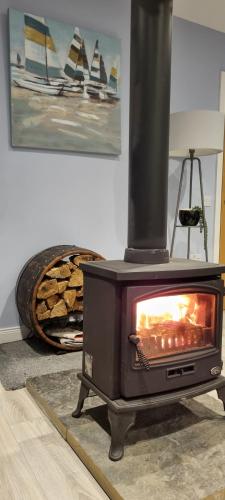 a stove sitting in a living room next to a wall at An Lochan in Manish
