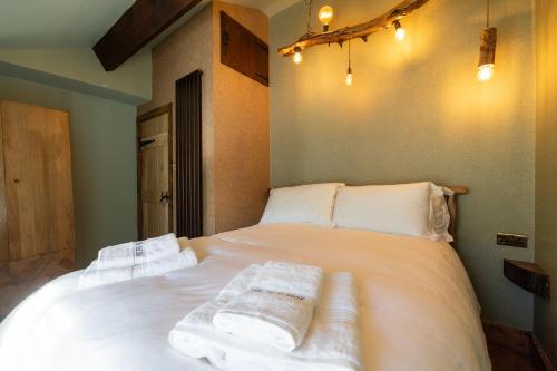 a bedroom with a white bed with towels on it at The Bolt Hole in Morecambe