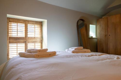 a bedroom with a bed with towels on it at The Bolt Hole in Morecambe