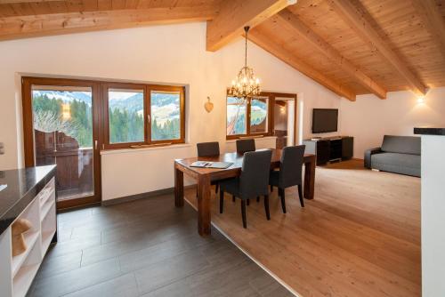 a dining room and living room with a table and chairs at Natural Deluxe Apartments Alpbach in Alpbach