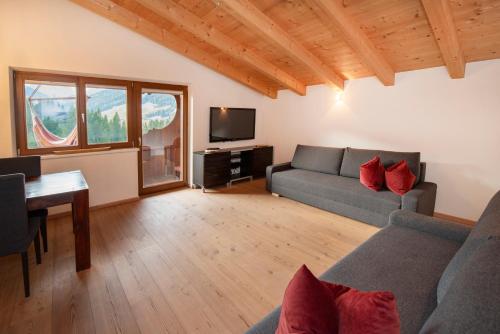 a living room with a couch and a table at Natural Deluxe Apartments Alpbach in Alpbach