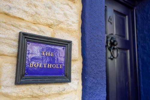 a sign on the side of a building next to a door at The Bolt Hole in Morecambe