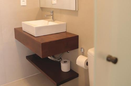 a bathroom with a sink and a toilet at Pousada Calza - Vale dos Vinhedos - Bento Gonçalves in Bento Gonçalves