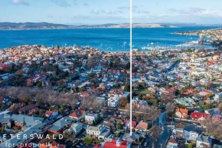 an aerial view of a city with the ocean at Charming inner city home excellent base in Hobart in Hobart