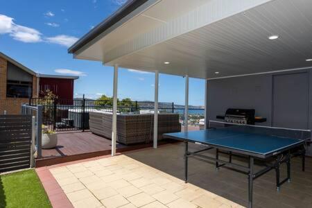 une maison avec une table de ping-pong sur une terrasse dans l'établissement River View Holiday House Sleeps 8 10min to CBD, à Hobart