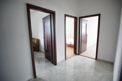 an empty room with two doors and a bedroom at Apartment U Černého Orla in Karlovy Vary