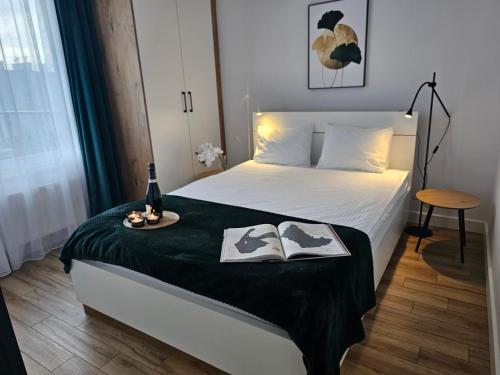 a bedroom with a bed with two books on it at URBAN APARTMENTS PREMIUM, Opolska 10 No 67A, Free Garage, Self Check-in in Katowice