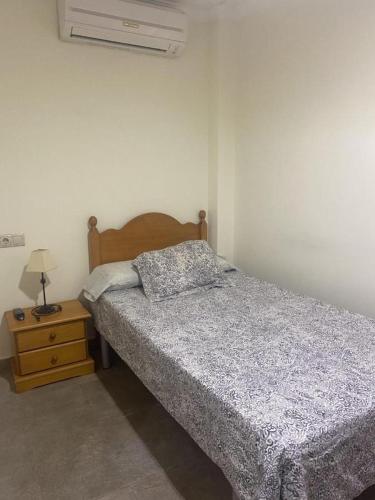 a bedroom with a bed and a night stand at Ca' La Conchin in Cortez de Pallas