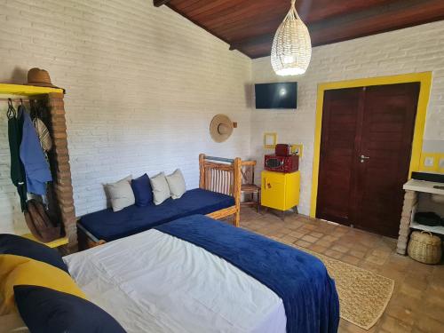 a bedroom with two beds with blue sheets in it at Porto do Sol - Chalé 25 in Pipa