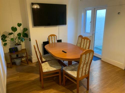 a dining room with a wooden table and chairs at The Brougham House in Bath