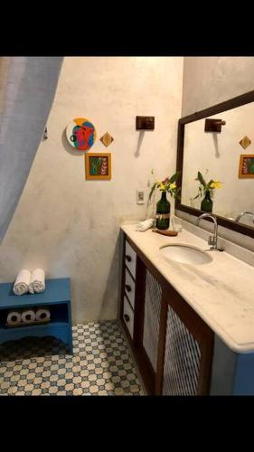 a bathroom with a sink and a mirror at Dellacasa in Jericoacoara