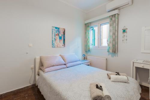 a bedroom with a bed with two towels on it at Achilleion Holiday Home in Achílleion