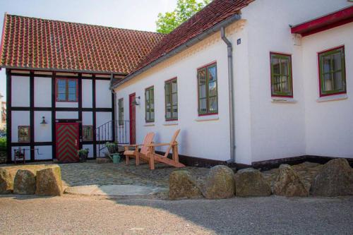 a house with a bench in front of it at The Mill House - Saeby Watermill in Sæby