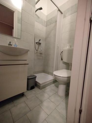 a bathroom with a toilet and a sink and a shower at EasyRoom Schio in Schio