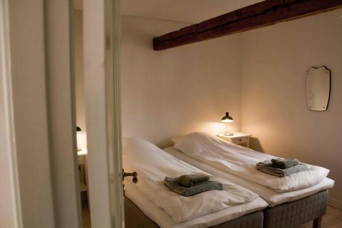 a bedroom with a bed with two towels on it at The Mill House - Saeby Watermill in Sæby