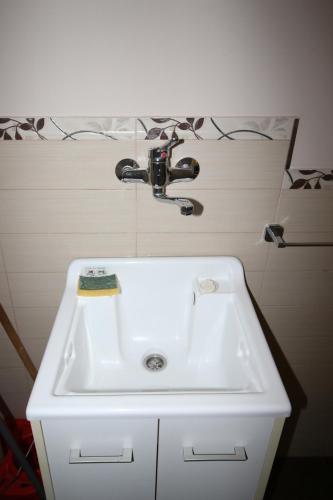 a sink with a faucet in a bathroom at Casa 4 Archi in Lentini