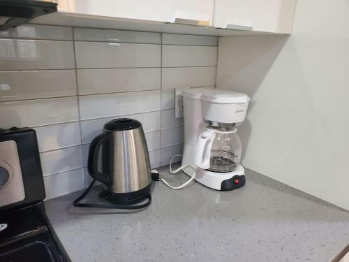 a coffee maker sitting on a counter in a kitchen at Stunning 1 bedroom condo in Calgary with riverview in Calgary