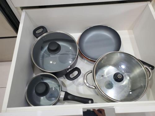 a white box with four pans on a stove at Stunning 1 bedroom condo in Calgary with riverview in Calgary