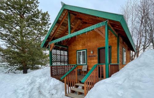 a wooden cabin in the snow in the snow at Chinook Wind Cabins in Talkeetna