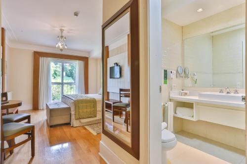 a bathroom with a toilet and a sink at Carballo Hotel & Spa in Campos do Jordão