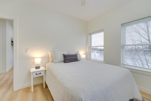 a white bedroom with a bed and two windows at St Clair Apartment Near St Clair City Boat Harbor! in Marysville