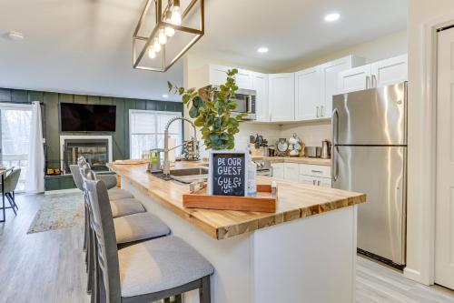 a kitchen with white cabinets and a stainless steel refrigerator at East Stroudsburg Townhouse Less Than 1 Mi to Ski Area! in East Stroudsburg