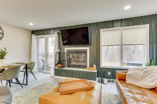 a living room with a couch and a fireplace at East Stroudsburg Townhouse Less Than 1 Mi to Ski Area! in East Stroudsburg
