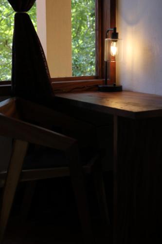a chair sitting in front of a desk with a lamp at Casa AVA in Mazunte