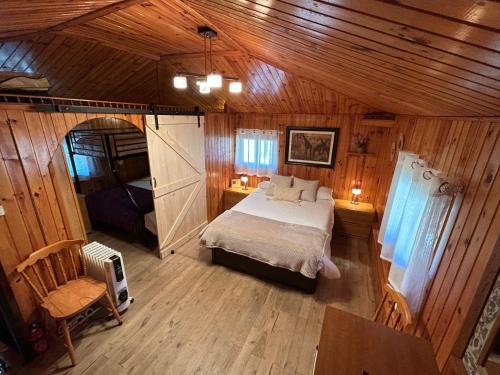 sypialnia z łóżkiem w drewnianym domku w obiekcie Finca del Hórreo 