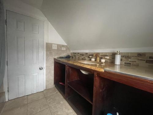 a kitchen with a counter and a sink at Private Loft 5 min away from LGA in East Elmhurst