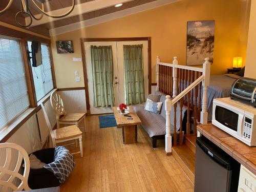 a living room with a couch and a microwave at Beach Casita - Allyn Inn in Shelton