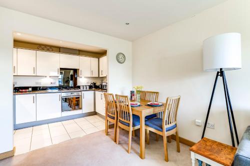 a kitchen and dining room with a table and chairs at Entire 2 Bed Flat Contractors Families and Relocators in Ware