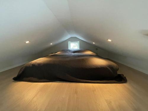 a large bed in the corner of a room at Eget hus anno 2024 Danderyd, 15min till STHLM city in Danderyd