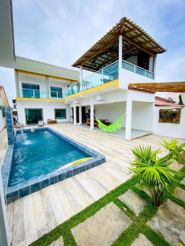 a house with a swimming pool in front of it at Villa Prado in Prado