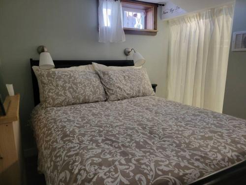 a bedroom with a bed and a window at 1 bedroom basement apartment with free parking in Brampton