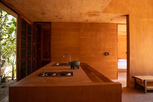 a kitchen with a sink and a counter top at Mazul Puerto Escondido in Tlachicón