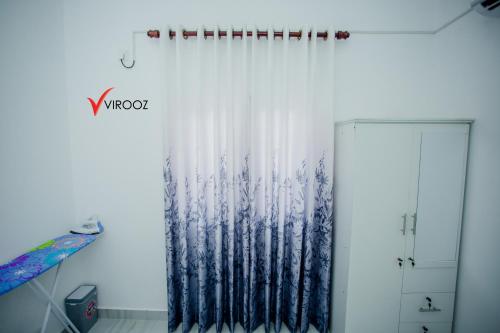 a room with a shower curtain and a door at Virooz Residence Rathmalana 2 Bedroom Apartment in Borupane