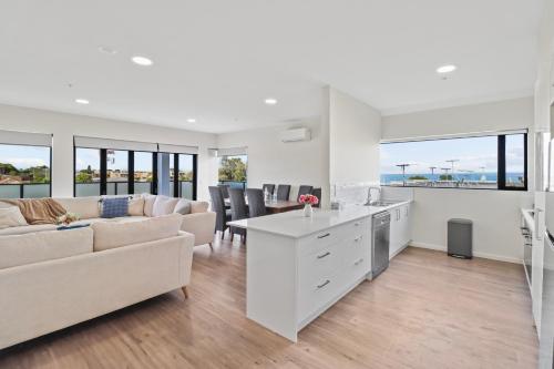 a kitchen and living room with a couch and a table at York St Apartments in Geelong