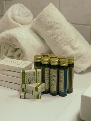 - une étagère avec des médicaments et des serviettes dans la salle de bains dans l'établissement Appartement Proche U Arena et La Défense, à Nanterre