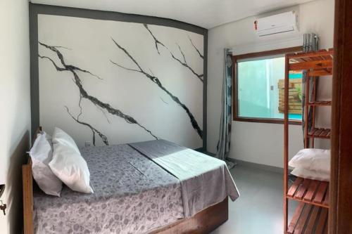a bedroom with a bed with a branch mural on the wall at Villa Prado in Prado