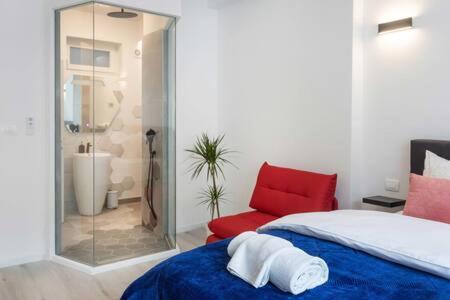 um quarto com uma cama e uma cadeira vermelha em Lux Nest II City Apartment URBAN STAY em Zagreb
