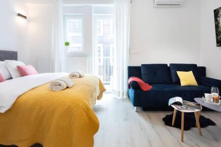 a bedroom with a large bed and a couch at Lux Nest I City Apartment URBAN STAY in Zagreb